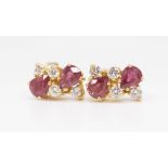 A pair of fancy 18ct ruby and diamond set earrings each comprising six stones.
