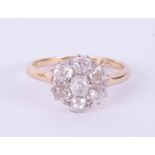 An 18ct diamond cluster ring set with seven stones, total weight approximately 1ct in yellow gold,