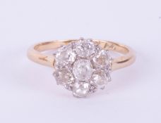 An 18ct diamond cluster ring set with seven stones, total weight approximately 1ct in yellow gold,