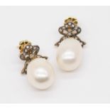 A pair of large pearl and diamond set antique earrings, the pearl diameter approximately 11mm.