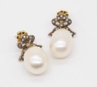 A pair of large pearl and diamond set antique earrings, the pearl diameter approximately 11mm.