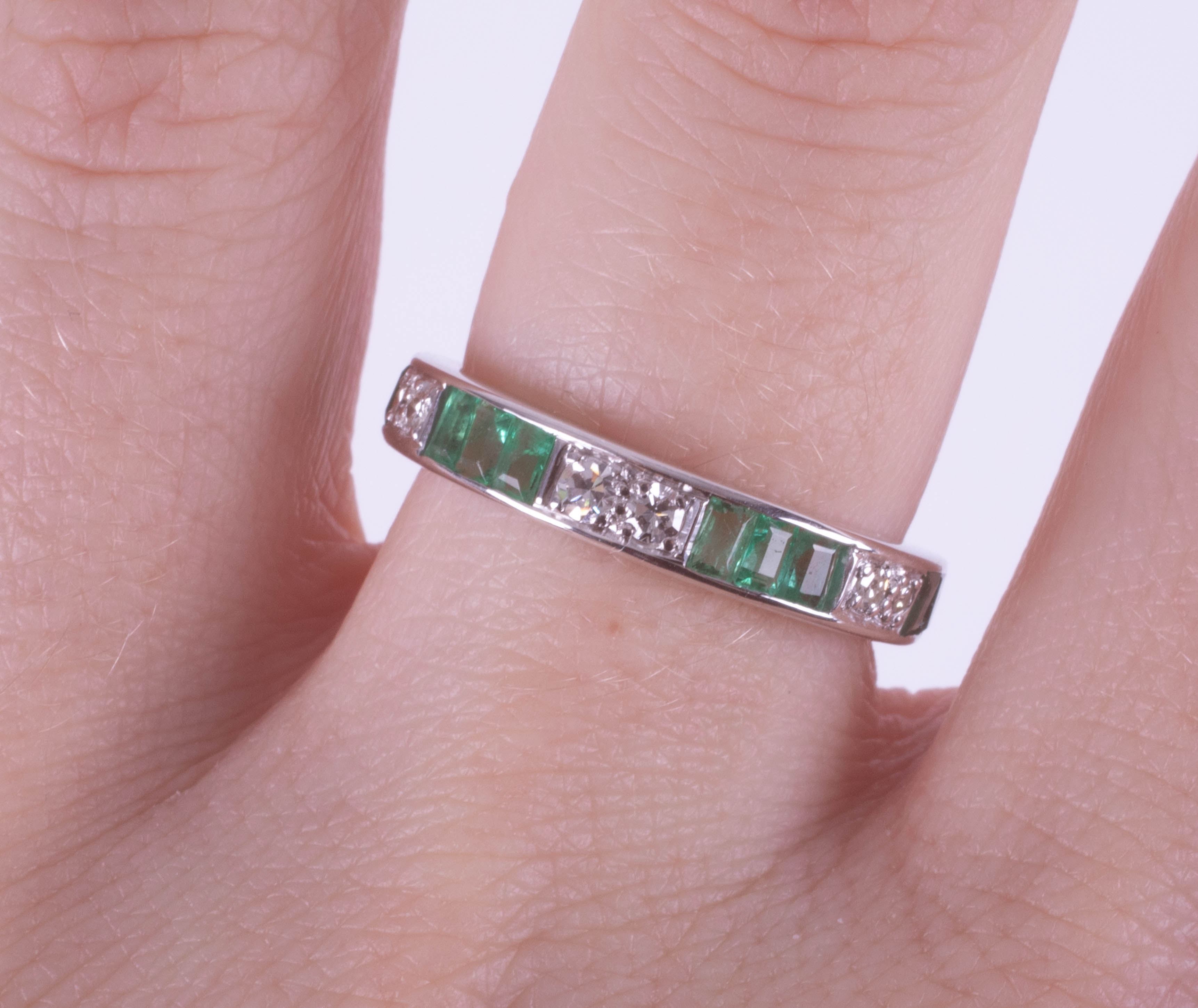 An 18ct white gold emerald and diamond half eternity ring, size M. - Image 2 of 2