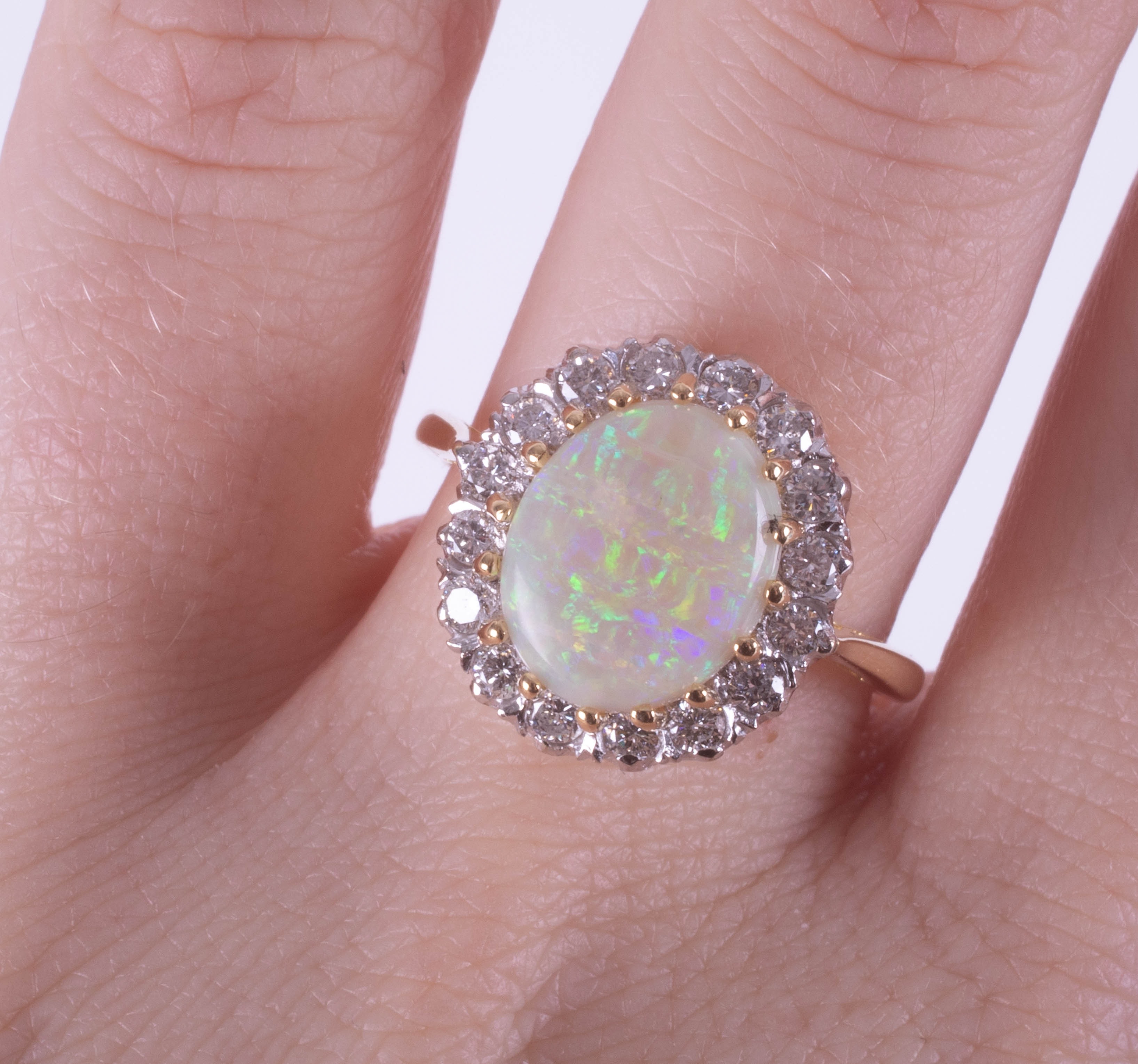 An 18ct white and yellow gold oval opal and diamond cluster ring, size P. - Image 2 of 2