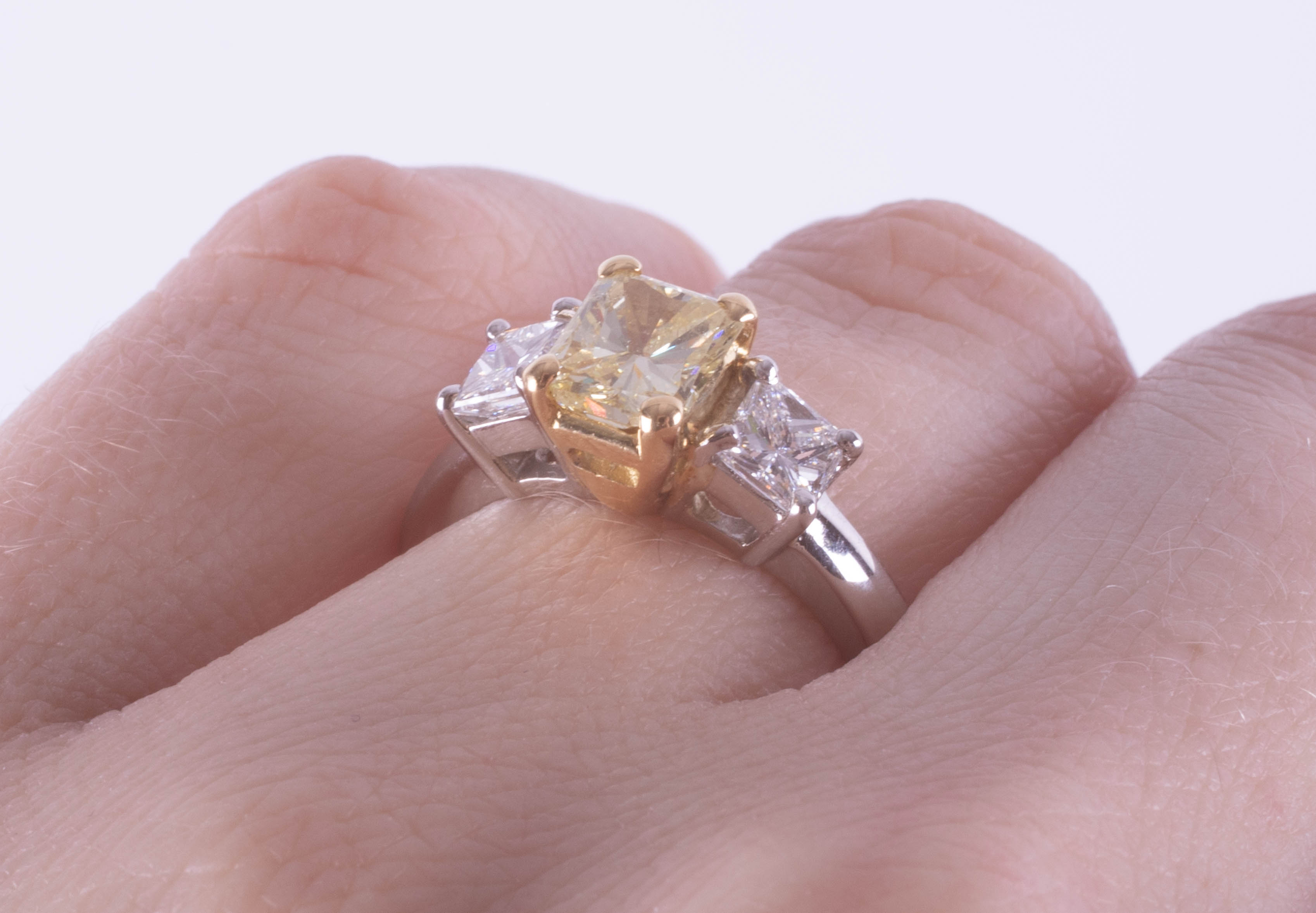 A fine 18ct diamond three stone ring, the centre stone yellow colour, two outer stones princess cut, - Image 9 of 9