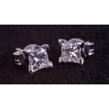 A pair of 18ct white gold 4 claw-set princess cut diamond studs, boxed. Diamonds 0.74ct.