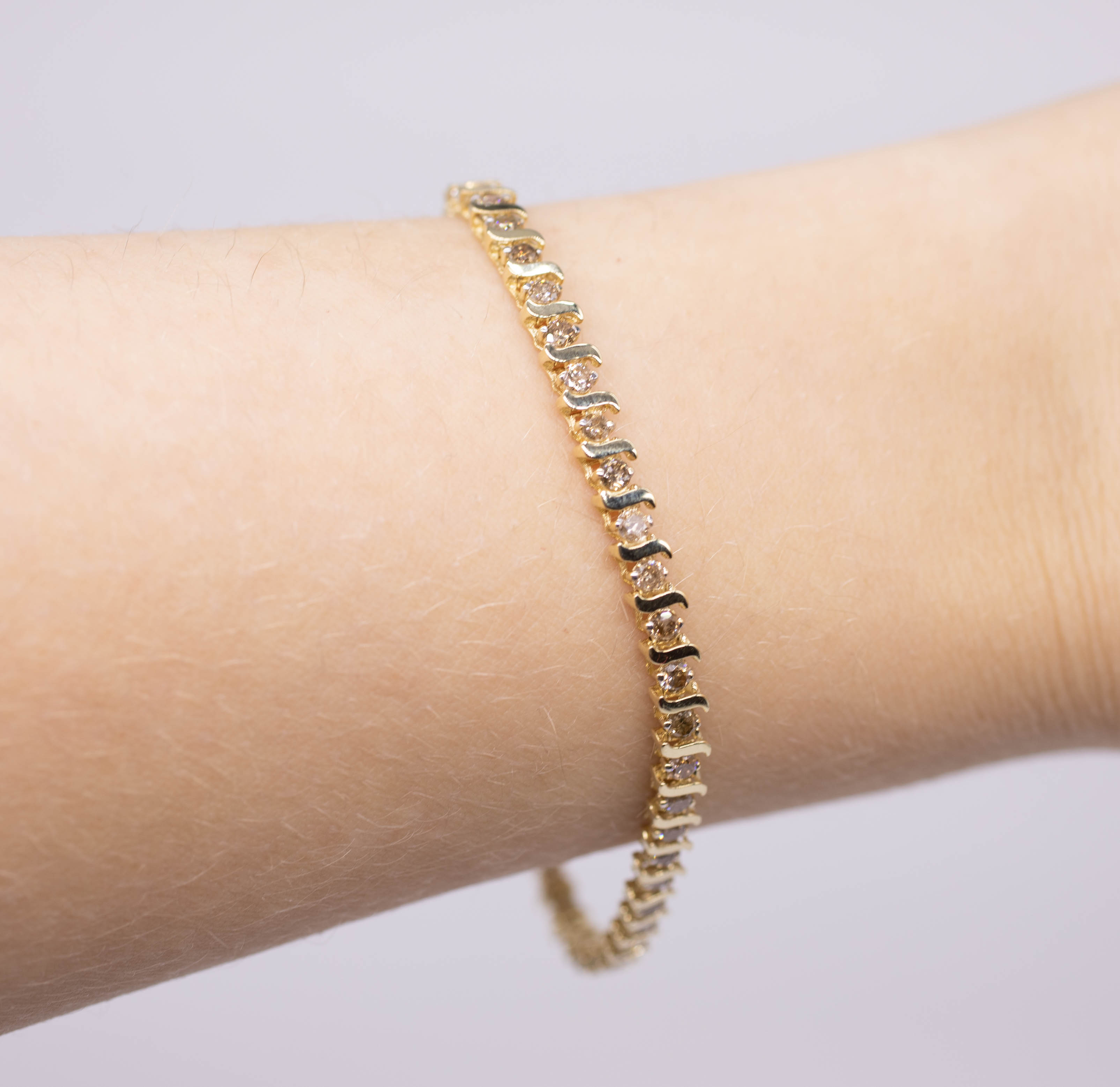 A diamond bracelet set in 10ct yellow gold, length 18cm. - Image 2 of 2