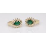 A pair of emerald and diamond set cluster earrings in 14ct yellow gold.