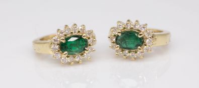 A pair of emerald and diamond set cluster earrings in 14ct yellow gold.
