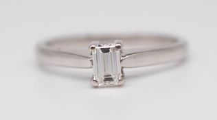 An 18ct white gold solitaire ring set with an emerald cut diamond approximately 0.25ct, size L.