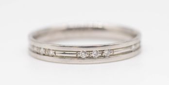 A platinum and diamond set band ring, size N.