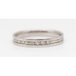 A platinum and diamond set band ring, size N.