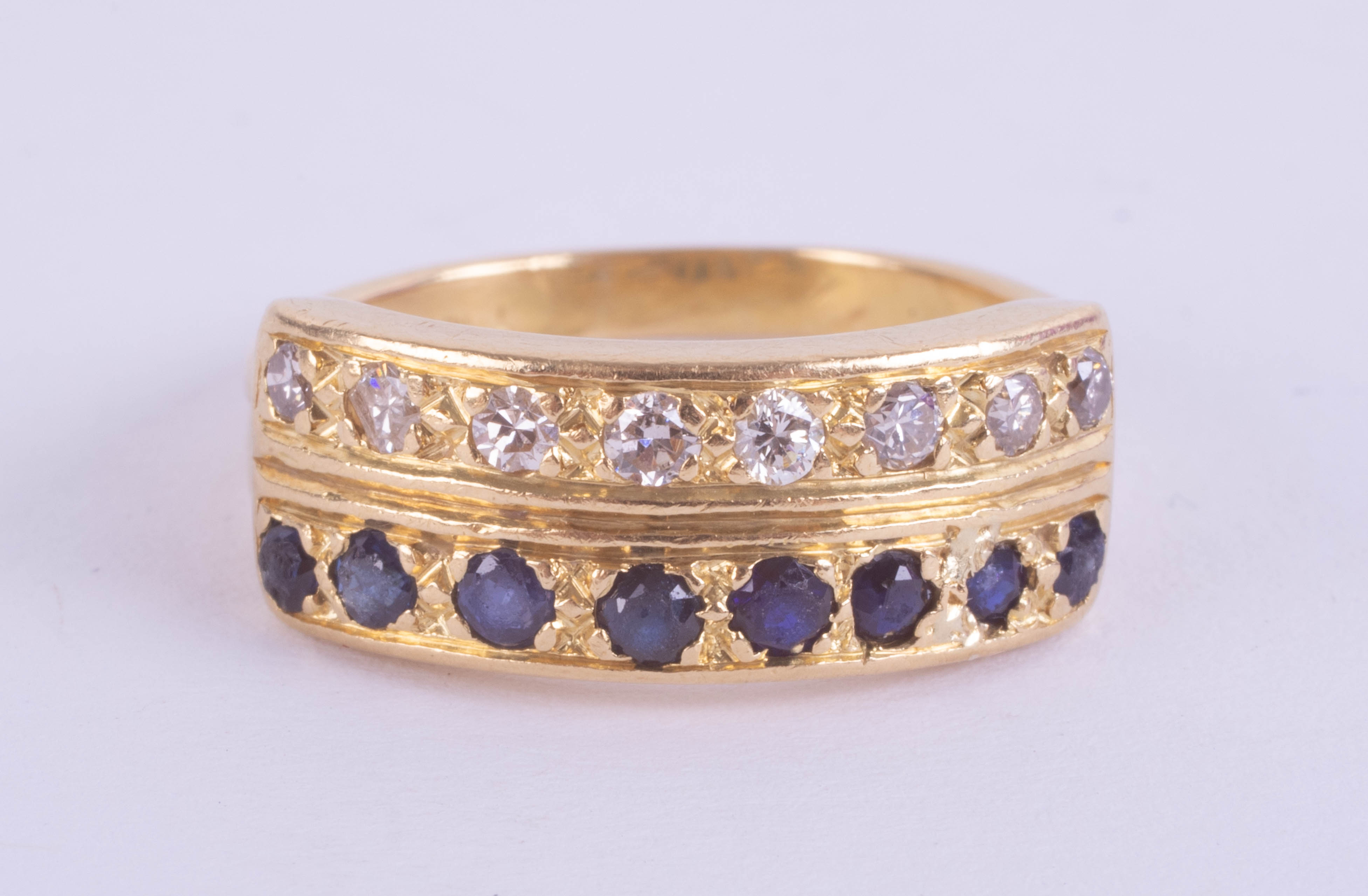 An 18ct sapphire and diamond two row ring, set with 16 stones in yellow gold, ring size N.