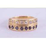 An 18ct sapphire and diamond two row ring, set with 16 stones in yellow gold, ring size N.