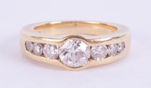 An 18ct diamond set seven stone ring, the central diamond approximately 0.80ct, with a copy of a