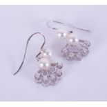 A pair of 9ct white gold diamond and cultured pearl drop earrings with an open wire fitting, total