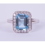 An 18ct white gold rectangular blue topaz and diamond cluster ring, size J.