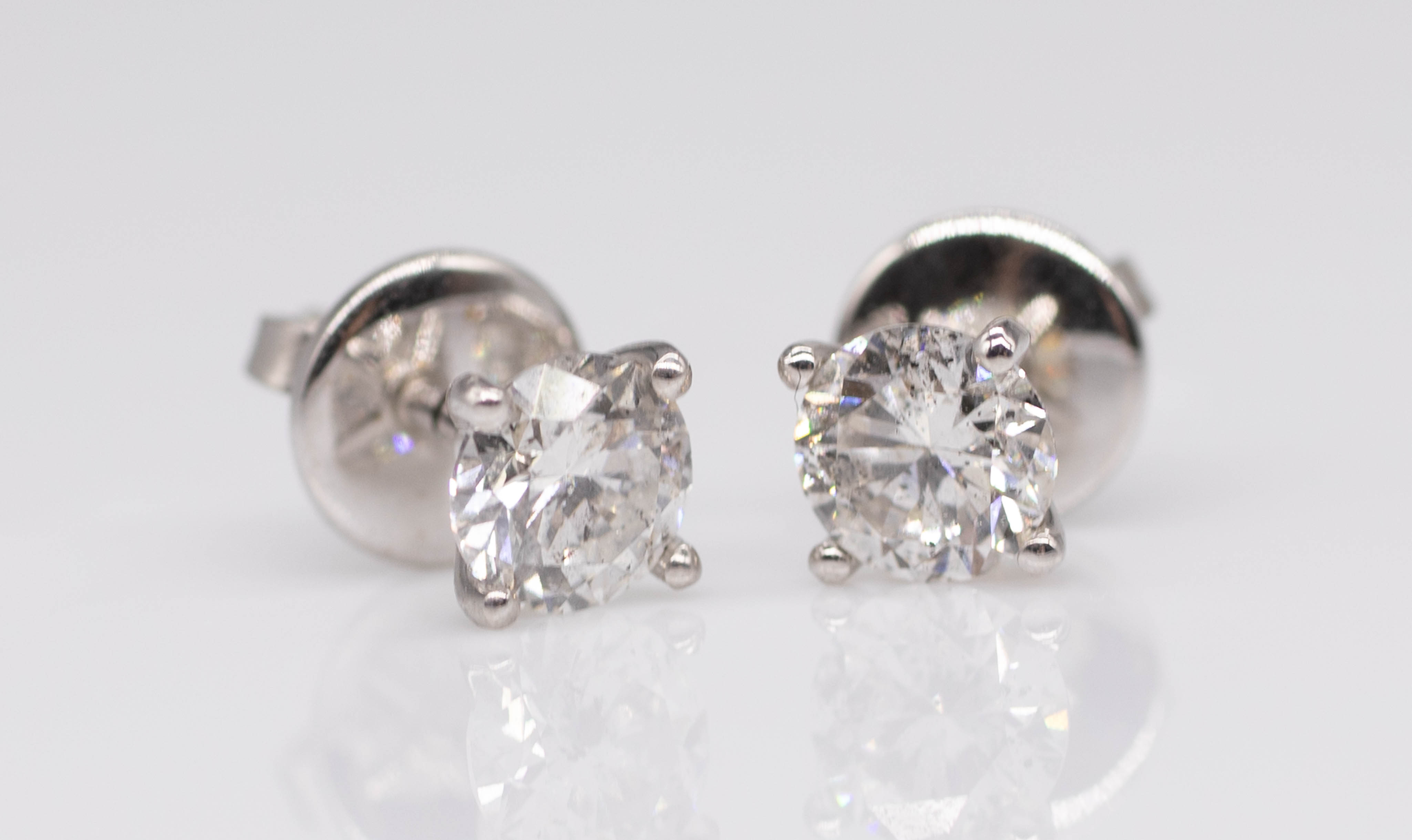 A pair of 18ct and diamond set stud earrings total weight approximately 1.20ct in white gold.