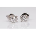 A pair of 18ct and diamond set stud earrings total weight approximately 1.20ct in white gold.