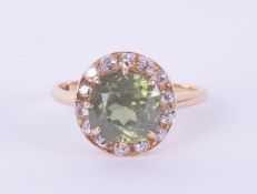 A green zircon and diamond set cluster ring, size T.