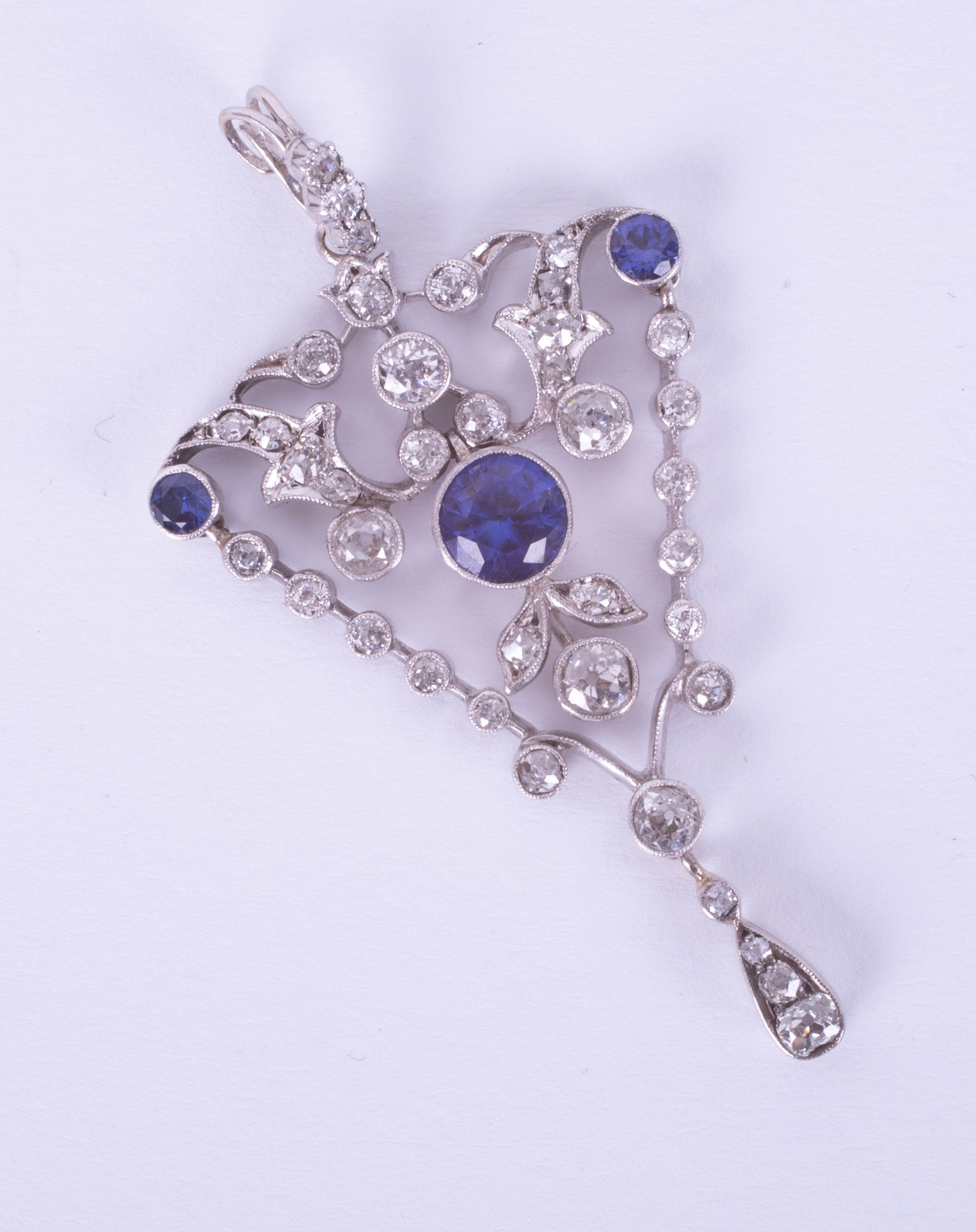 A fine diamond pendant, set with blue stones, overall length 59mm.