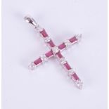 An 18ct white gold ruby and diamond cross pendant.