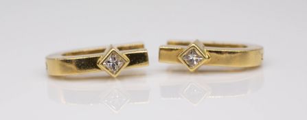A pair of 18ct yellow gold earrings, each set with a square cut diamonds, approximately 8.28g.