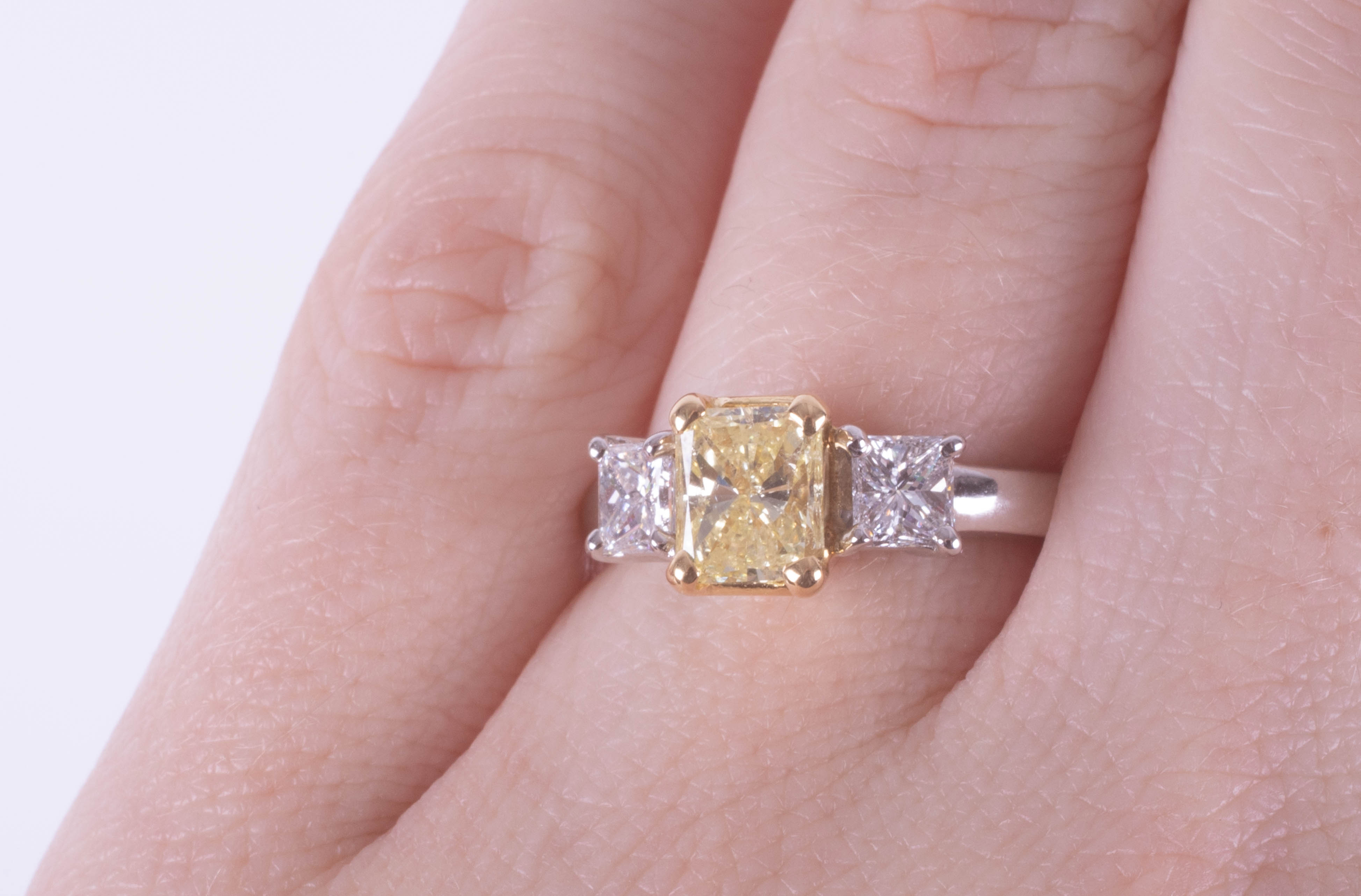 A fine 18ct diamond three stone ring, the centre stone yellow colour, two outer stones princess cut, - Image 2 of 9