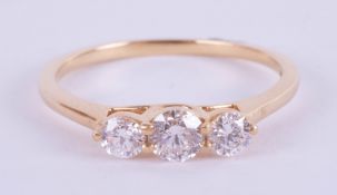 An 18ct yellow gold trilogy ring approx. 0.50ct, estimated colour and clarity E/SI1, ring size M.