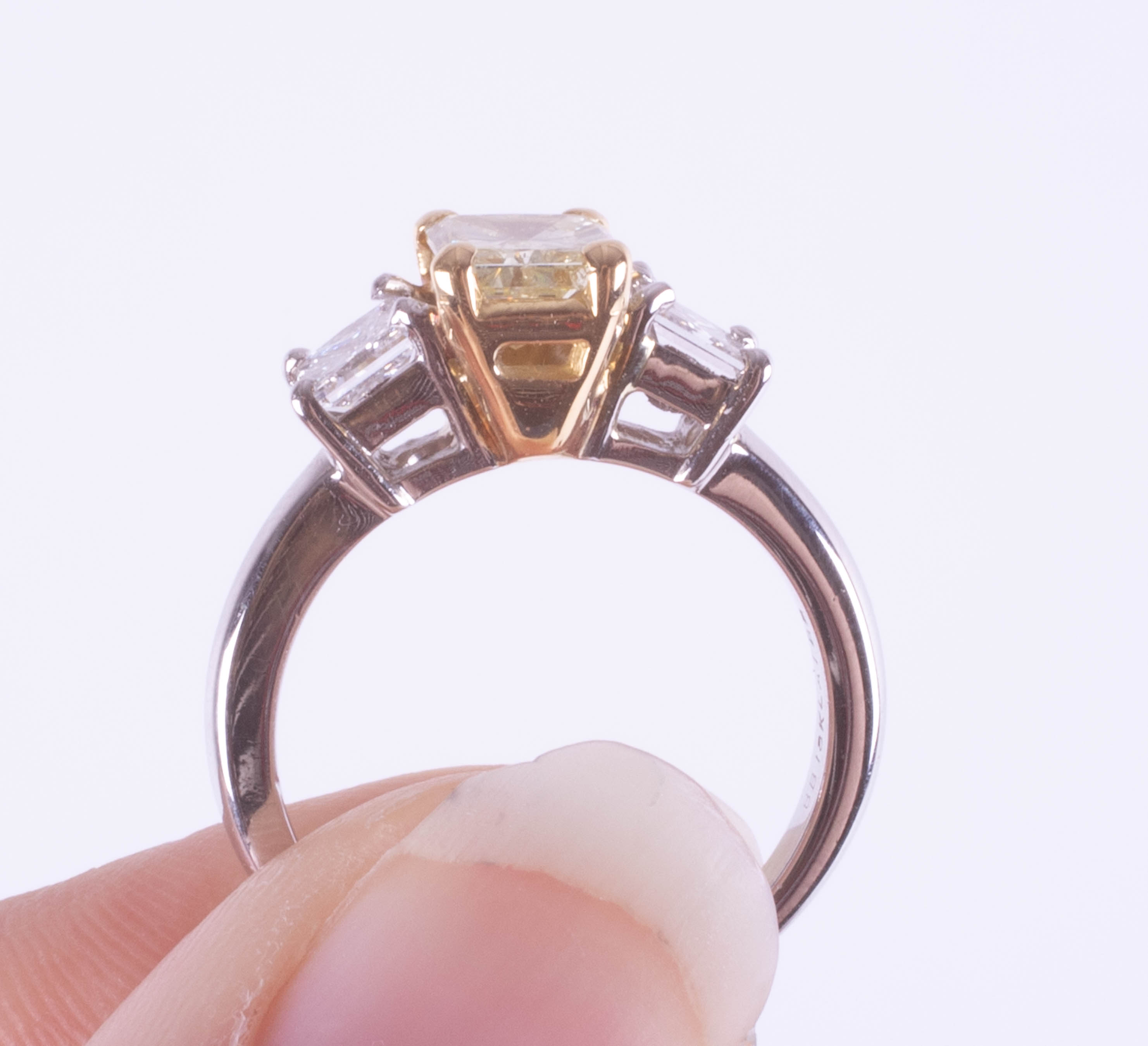 A fine 18ct diamond three stone ring, the centre stone yellow colour, two outer stones princess cut, - Image 7 of 9