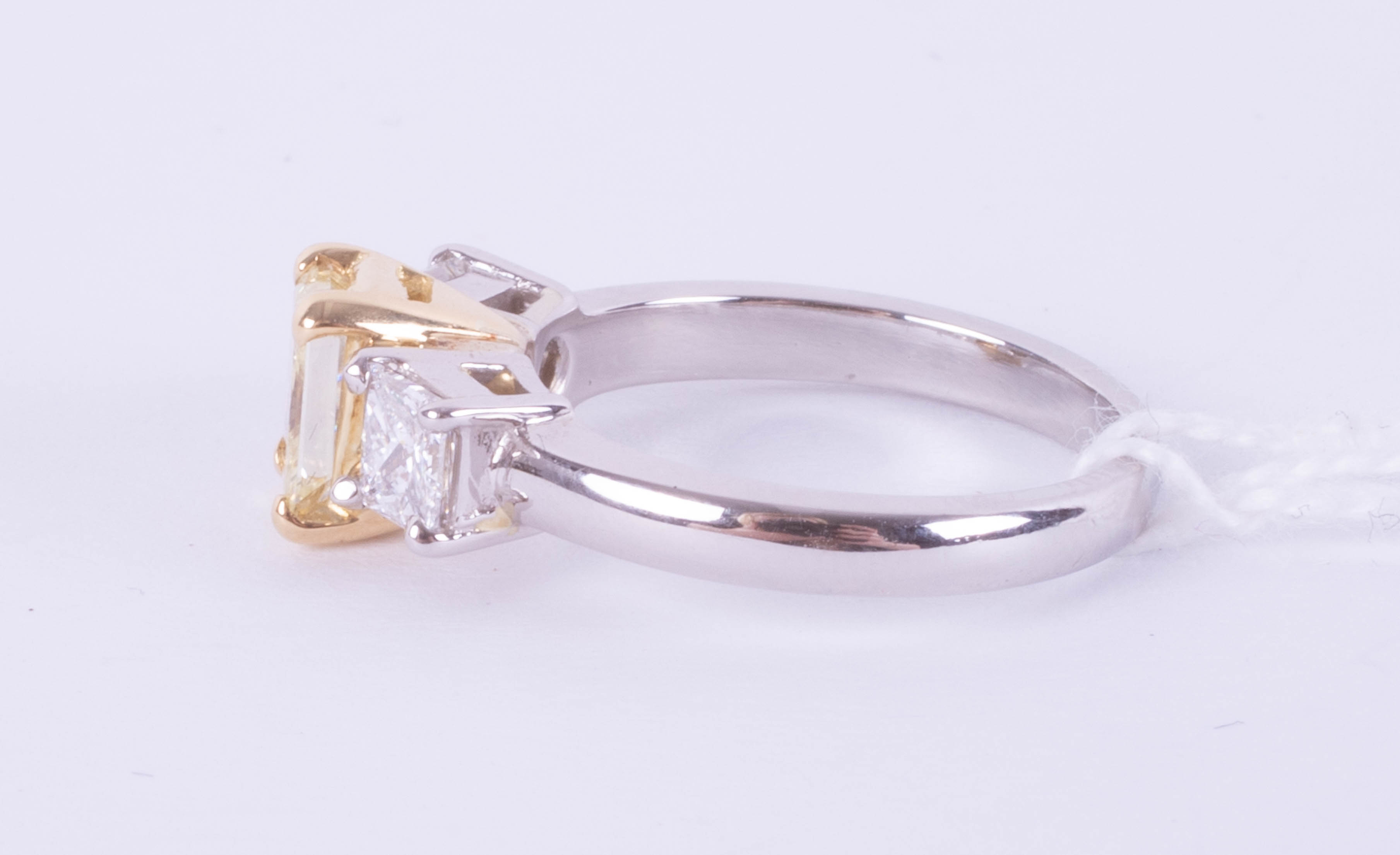 A fine 18ct diamond three stone ring, the centre stone yellow colour, two outer stones princess cut, - Image 5 of 9
