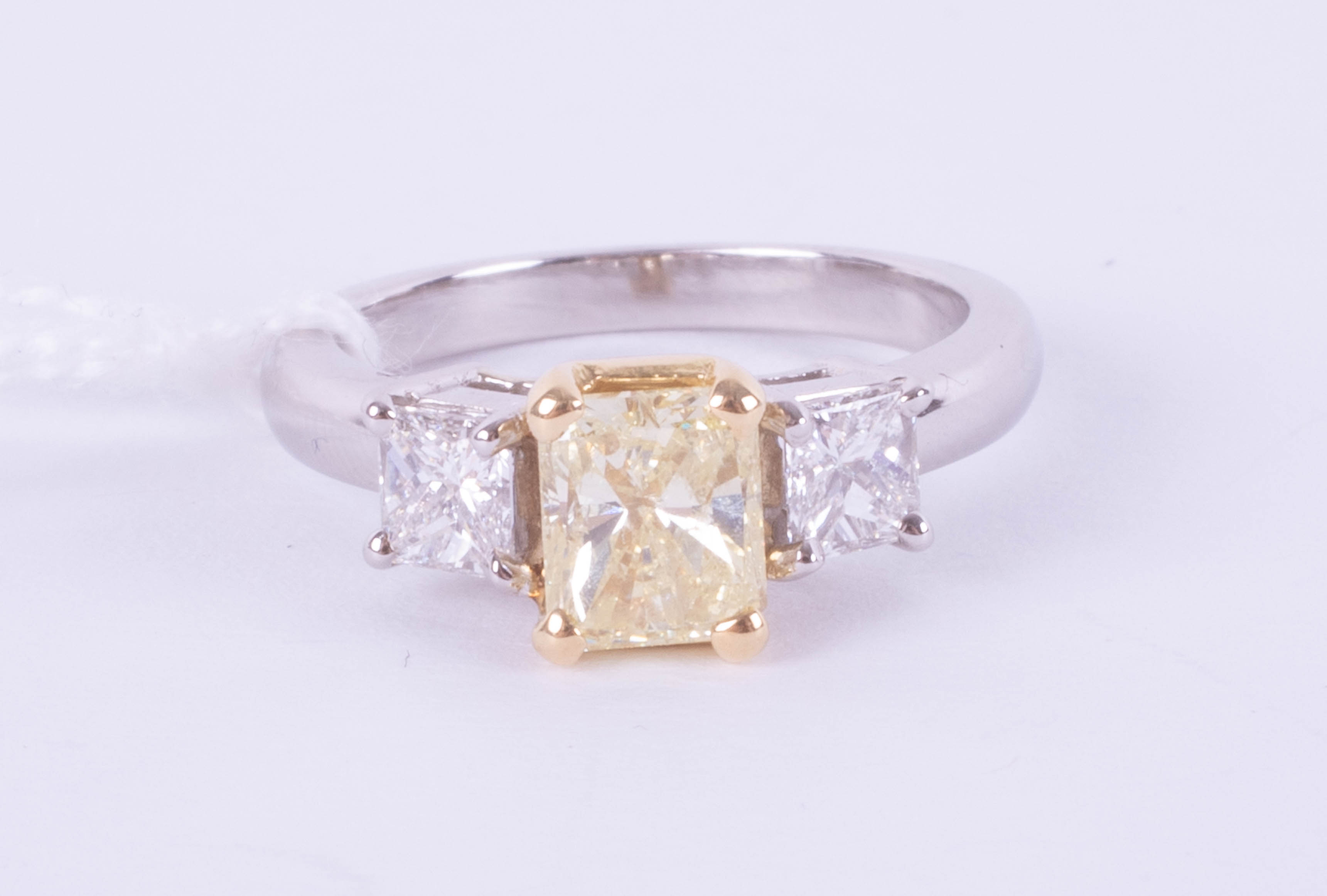 A fine 18ct diamond three stone ring, the centre stone yellow colour, two outer stones princess cut, - Image 3 of 9