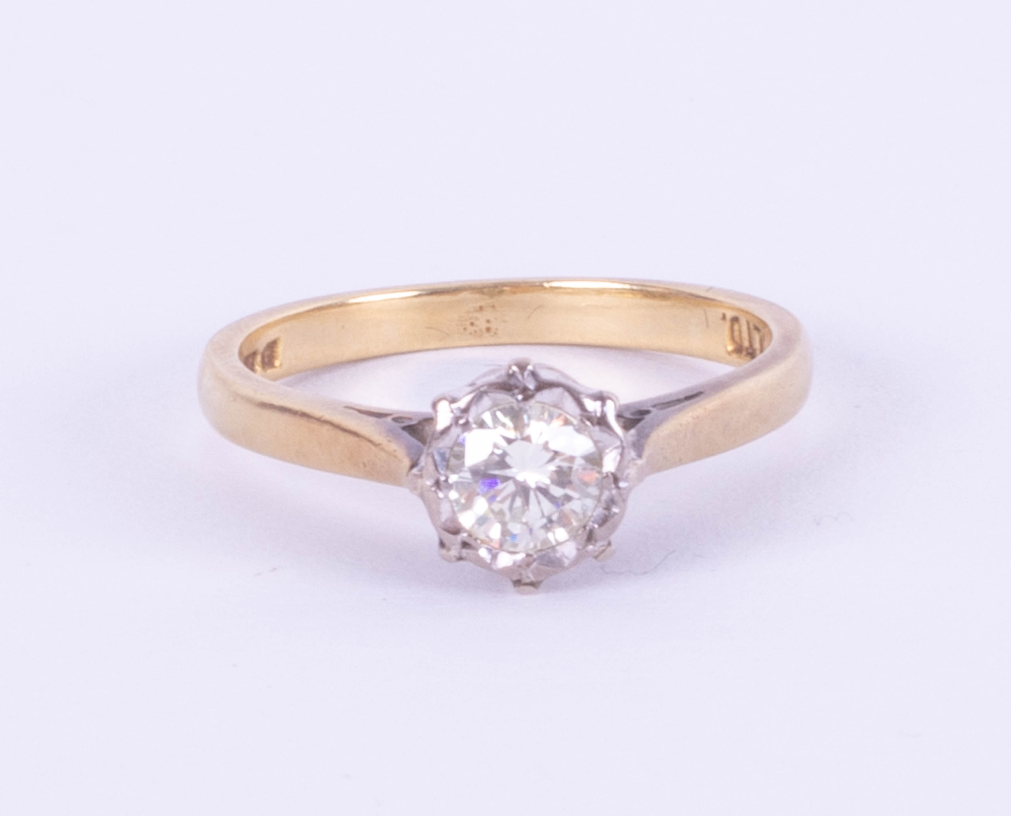 An 18ct diamond solitaire ring approximately 30 points, set in yellow gold, size L.