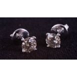 A pair of 18ct white gold solitaire diamond stud earrings, boxed. RBC diamonds approx 1.07ct.