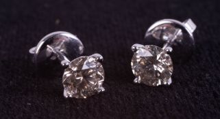 A pair of 18ct white gold solitaire diamond stud earrings, boxed. RBC diamonds approx 1.07ct.