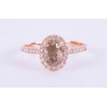 An 18ct rose gold champagne diamond halo set ring, approx. 1.10ct, ring size O.