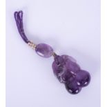 A large carved amethyst drop pendant, length of main carved stone 36mm, 23.35g.