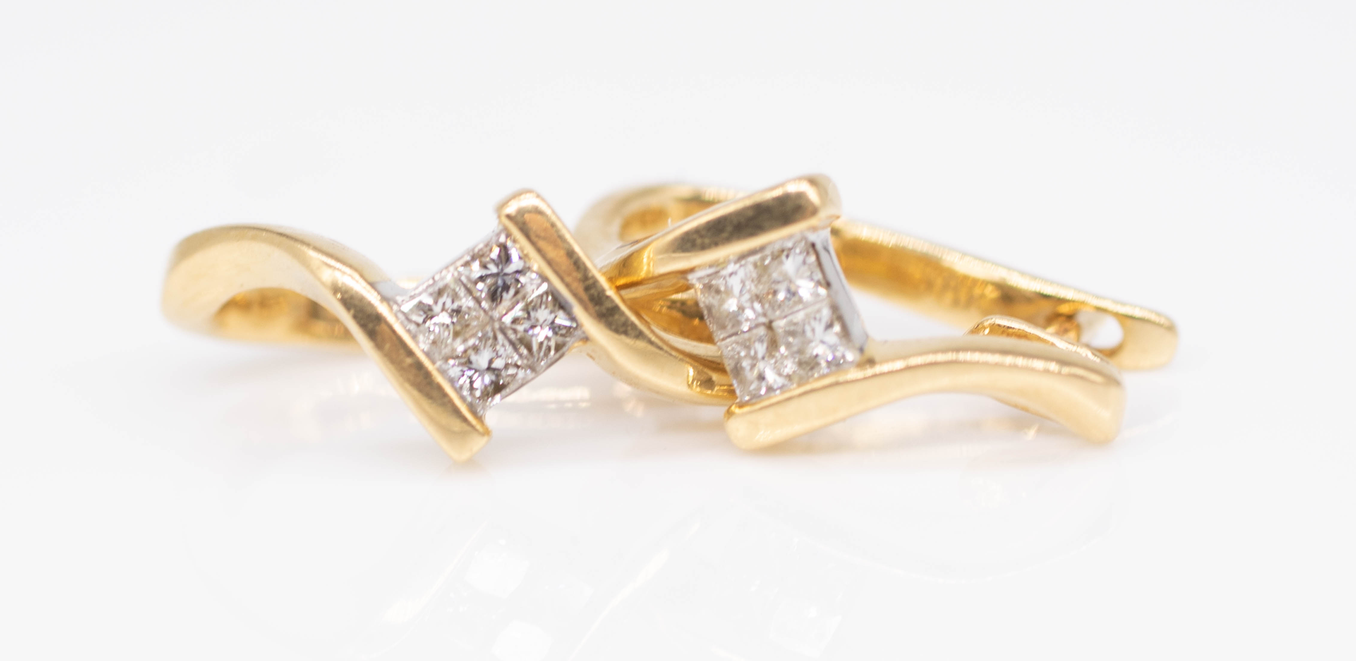 A pair 18ct yellow gold and princess cut diamond set earrings.