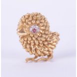 An 18ct gold, ruby and diamond brooch, designed as a chick, the eye mounted with a ruby and with