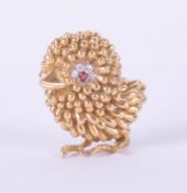 An 18ct gold, ruby and diamond brooch, designed as a chick, the eye mounted with a ruby and with