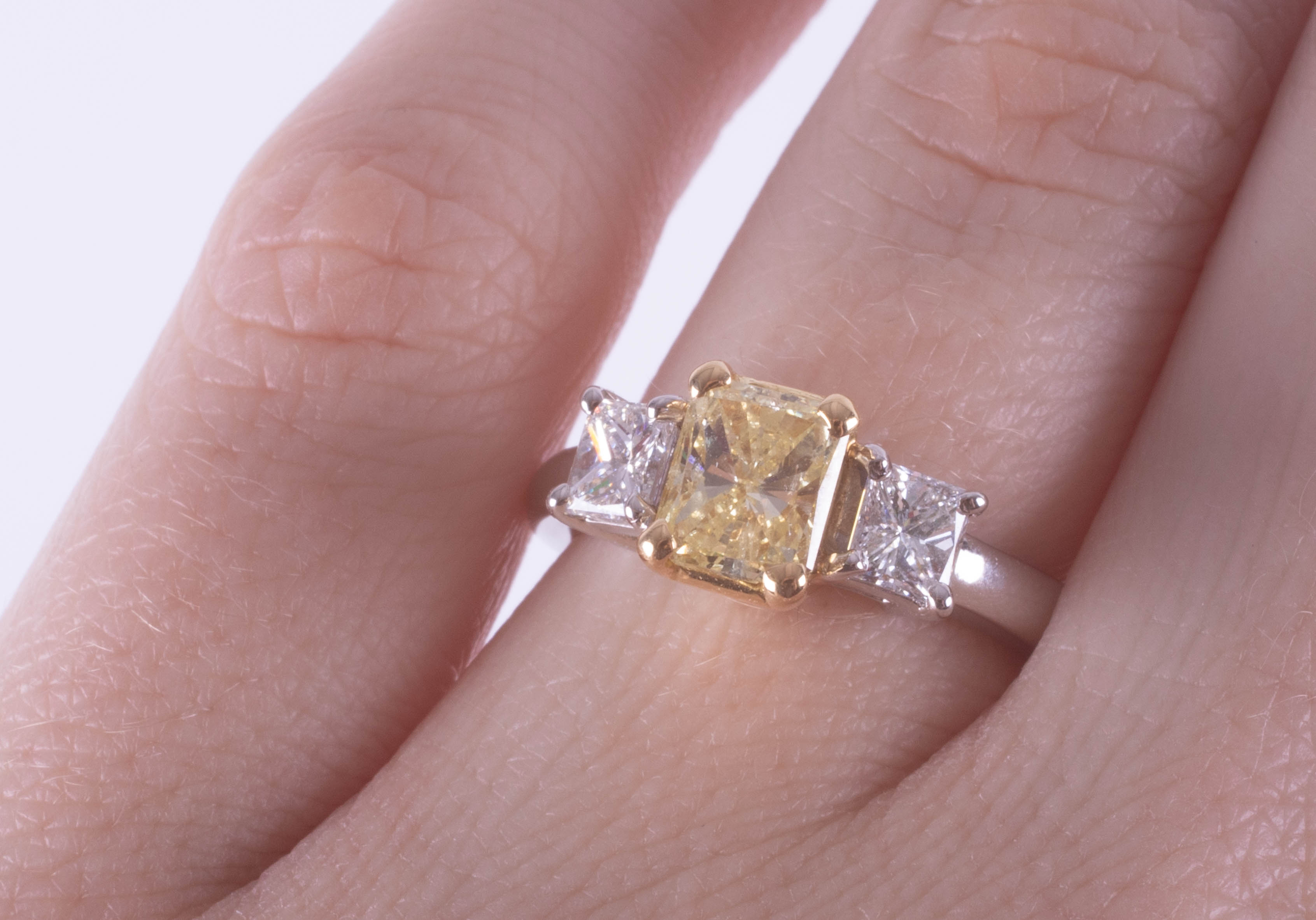 A fine 18ct diamond three stone ring, the centre stone yellow colour, two outer stones princess cut, - Image 8 of 9