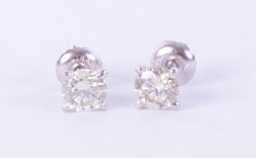 A pair of 14k white gold and diamond earrings, weight 1.09 carat, colour E-F, clarity VS1-VS2