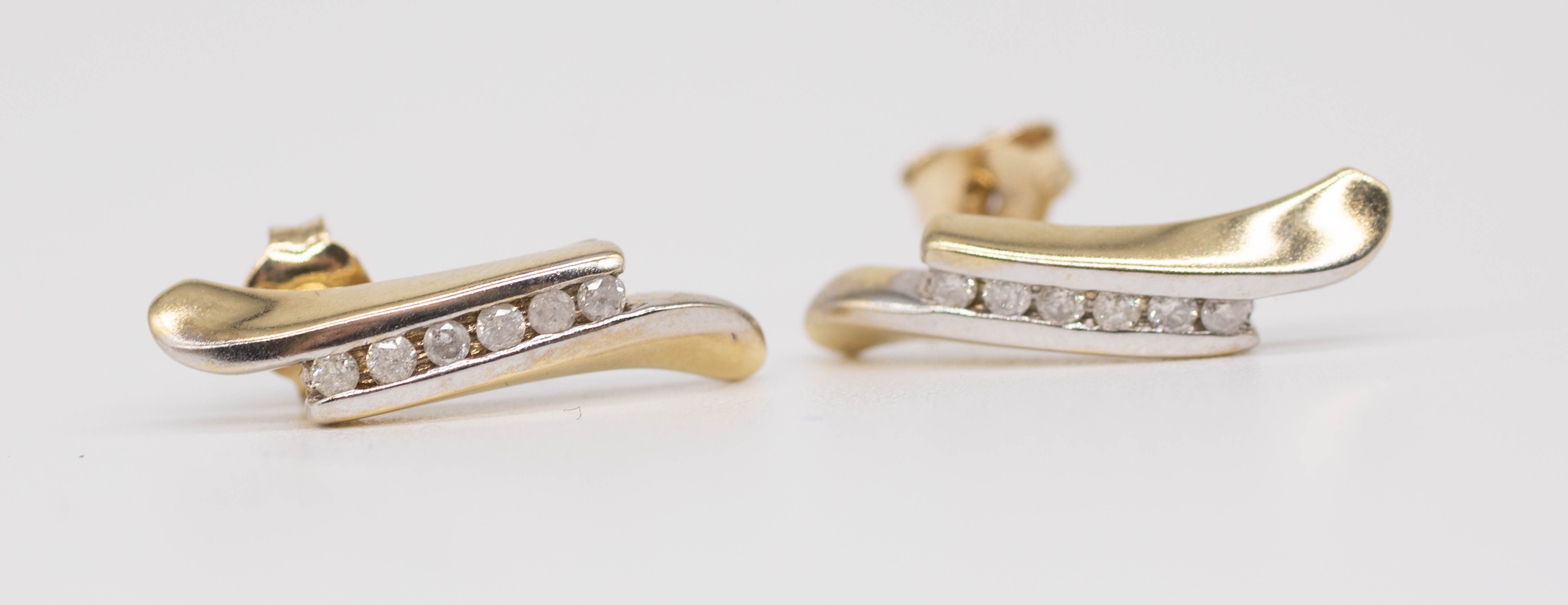 A pair of 9ct yellow gold and diamond set earrings of contemporary design.