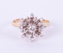 An 18ct diamond cluster ring set in yellow gold, size N.