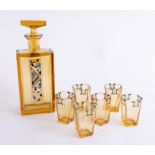 An Art Deco design amber glass seven piece drinks set comprising decanter, and six drinking