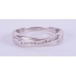 An 18ct white gold diamond set crossover ring size O.