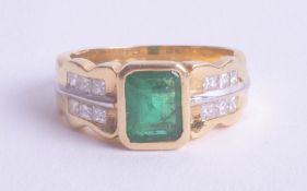 An 18ct yellow gold emerald and diamond ring, size O.