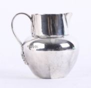 A silver early Victorian cream jug with plain bulbous body and ribbed fancy foliate handle, Young