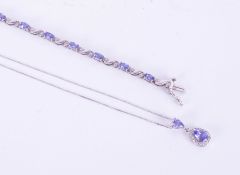 A 14ct tanzanite and diamond pendant necklace on fine chain and also a silver tanzanite