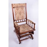 An Edwardian mahogany framed rocking chair.