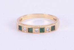 An 18ct emerald and diamond seven stone ring, size P.